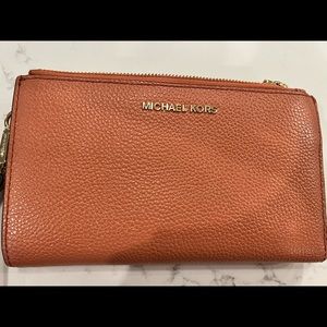 Michael Kors smartphone leather wallet/wristlet. Peachy orange color.
